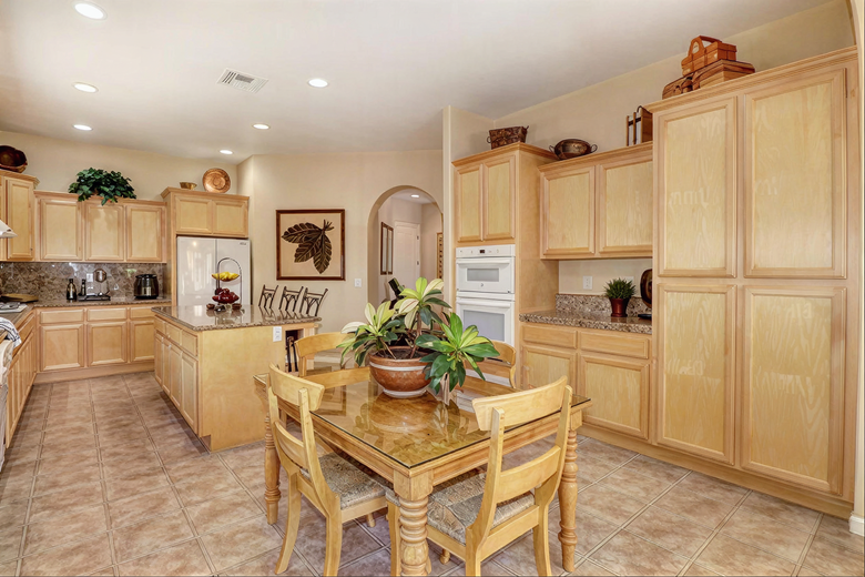Kitchen with maple cabinetry and dining table